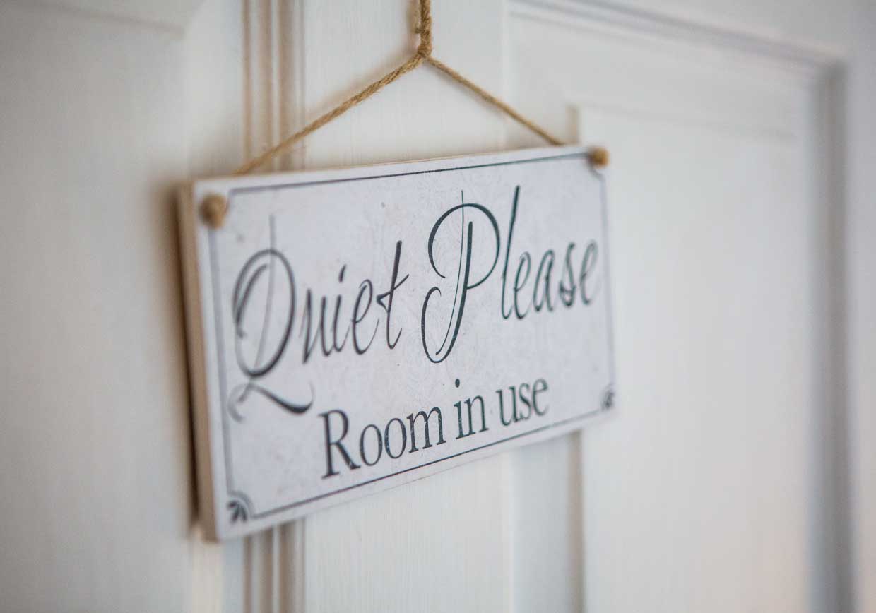 Sign on door, which reads 'Quiet Please. Room in use.'.
